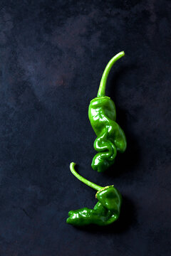 Green peperonis aon dark background