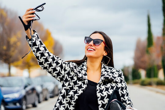 Business woman taking a selfie with a shoe