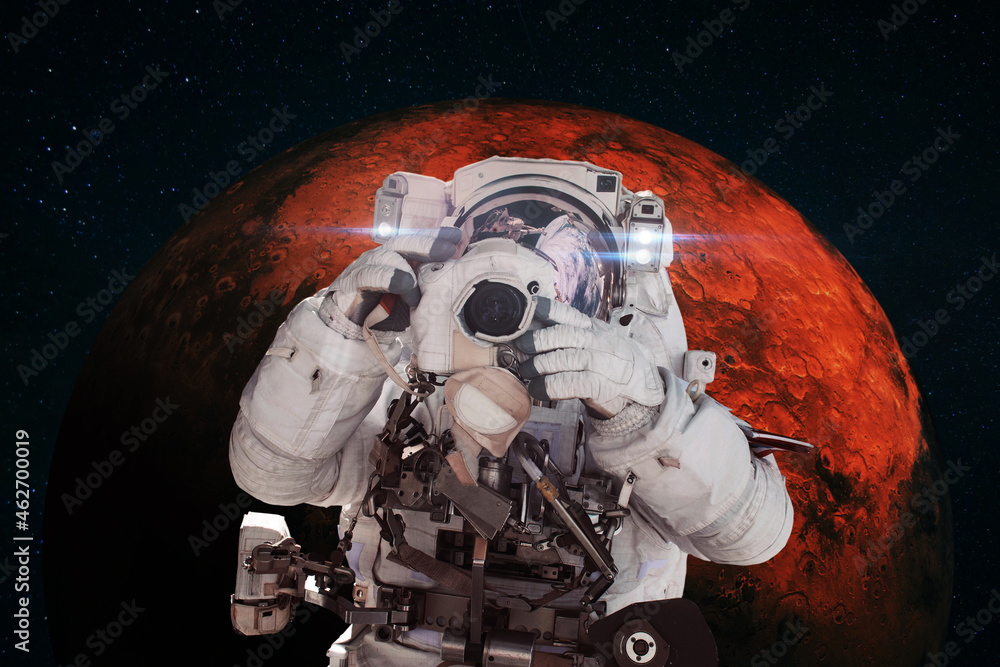 Aufkleber astronaut photographer with a camera taking pictures against the background of the red planet mars. 