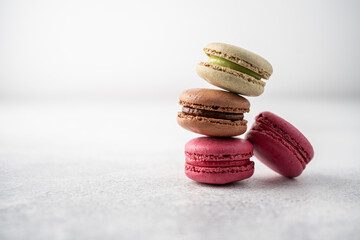 Set of French macarons, berry, pistachio, chocolate on white background
