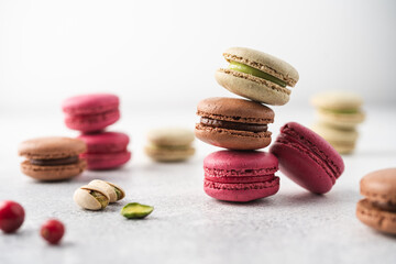Set of French macarons, berry, pistachio, chocolate on white background