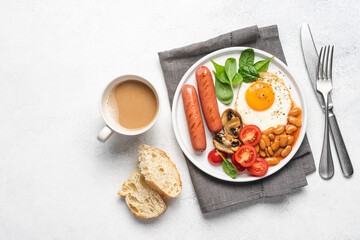 Obraz na płótnie Canvas Traditional English breakfast with fried egg, beans in tomato sauce, grilled sausages, mushrooms and fresh tomatoes, served on plate. White background^ flat lay