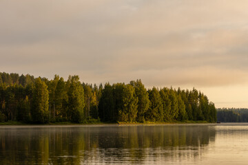 Beautiful sunrise in the woods overlooking a lake in Sweden. This is made in Näsåker in Västernorrland County and at the lake and river Ångermanälven.