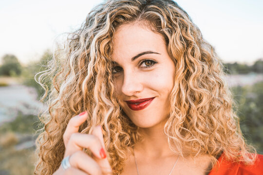 Portrait of blond young woman with red lips