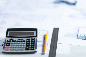 Photo of working tools on the desk like pencil, ruler and calculator.