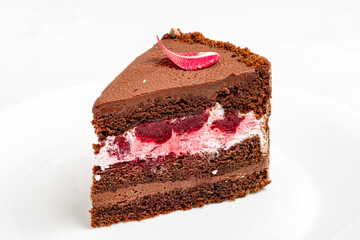 chocolate cake with berries and rose petals