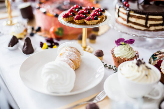 Dining table filled with all kinds of snacks and desserts