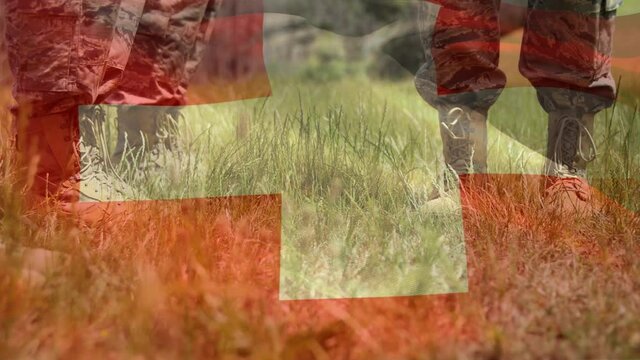 Animation of flag of switzerland waving over low section of soldiers