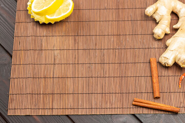 Ginger root and cinnamon sticks on table.