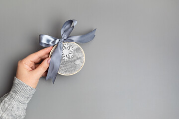 Diy project of christmas ornaments made of  old sweater and embroidery hoops in gray and silver colors. Easy handmade xmas decoration, gift idea, greeting card mockup. Flat lay, top view