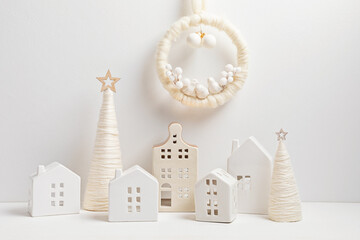 Christmas craft background with handmade yarn cone xmas trees and christmas wreath in white color....