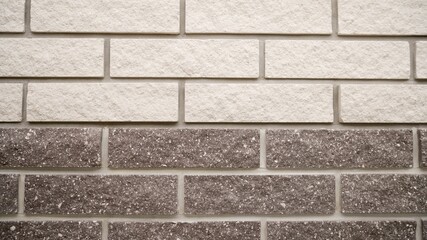 Decorative bricks are laid on the facade of the house. Hyper-pressed facing brick for masonry of a fence and a facade of buildings. The building is made of marble bricks. Facade bricks on the house.