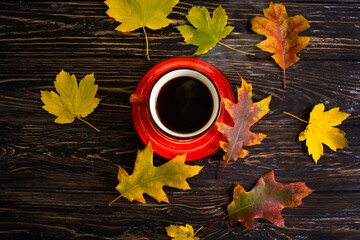coffee cup autumn leaf on wooden background