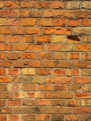 Old wall with scratched bricks close-up.