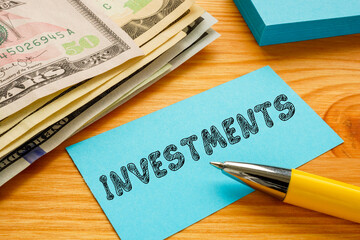 Financial concept meaning INVESTMENTS with inscription on the sheet.