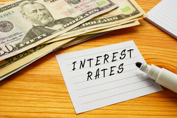 Business concept about INTEREST RATES with sign on the sheet.