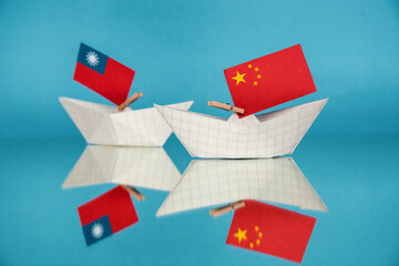 paper ship with national flag of china and Taiwan, concept of conflict tensions, shipment or free...