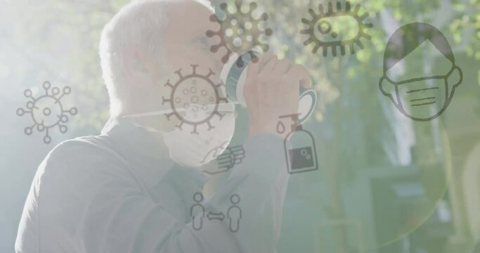 Animation of covid 19 icons over senior man wearing face mask