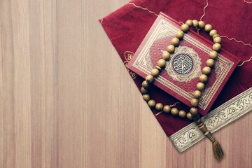 Holy Quran book with arabic calligraphies translation and Rosary beads