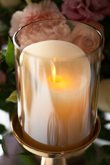 glass candle holder with burning candles close-up