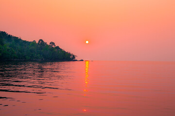 Bright sunset over the sea and the mountain. Evening sea landscape. Travel and tourism.