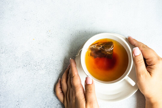 Overhead view of a woman enjoying a cup of tea