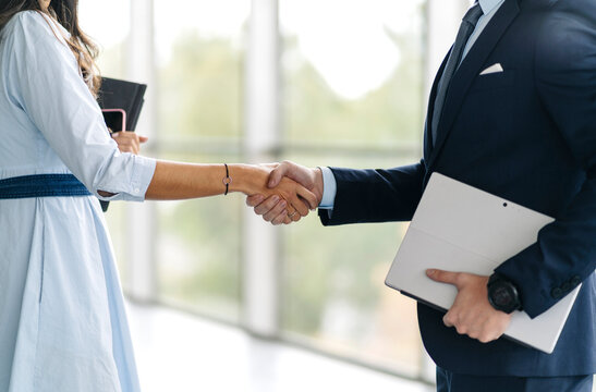 Close-up of businessman and businesswoman shaking hands