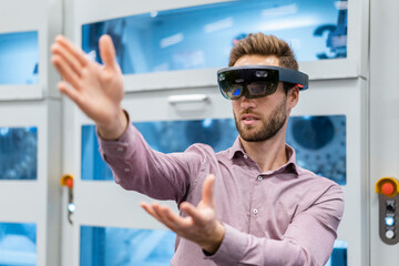 Businessman wearing AR glasses in a modern factory