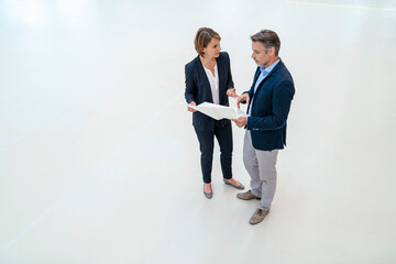 Businessman and businesswoman discussing plan