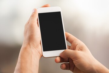 Man using mobile phone with a blank screen