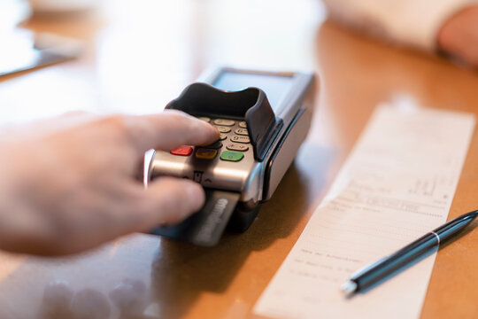 Man using credit card reader, close-up
