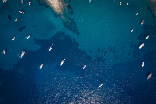 Italy, Province of Livorno, Elba, Aerial view of boats floating in blue waters of Mediterranean Sea