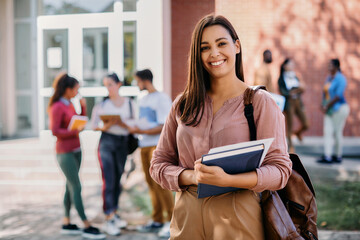 Portrait of happy female university student looks at camera.