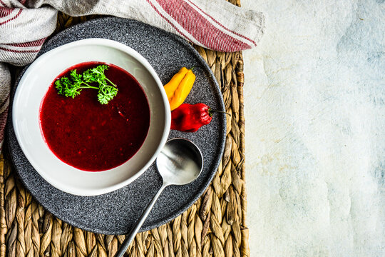 Bowl of creamy beetroot soup with chilli and parsley
