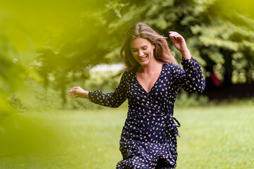 Smiling young woman in park