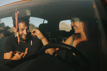 Couple exchanging car keys on a road trip