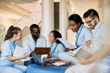 Multi-ethic group of medical students study in hallway at university.