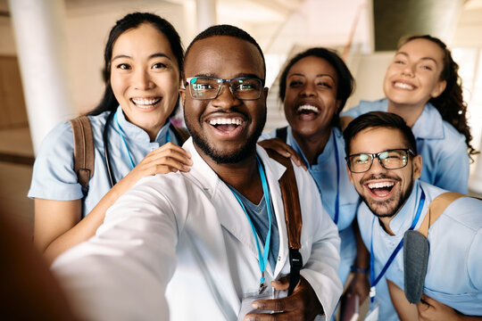 Cheerful medical students take selfie and having fun at university.