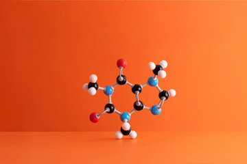 Caffeine formula's molecular structure over orange background