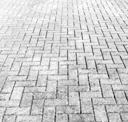 Full frame texture image of monochrome herringbone paving blocks with copy space