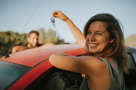 Couple exchanging car keys on a road trip