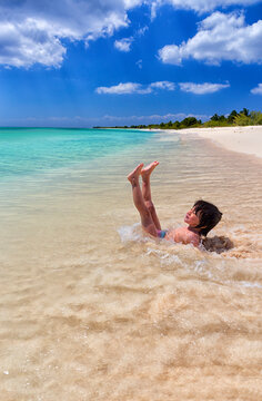 Shirtless girl enjoying on sea shore at beach during summer vacation, Punta Sur, Cozumel, Mexico