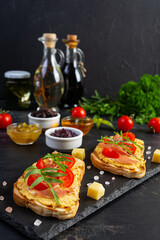 Grilled bruschetta with chicken rillettes, jamon and herbs. Delicious toast with chicken pate and different appetizers