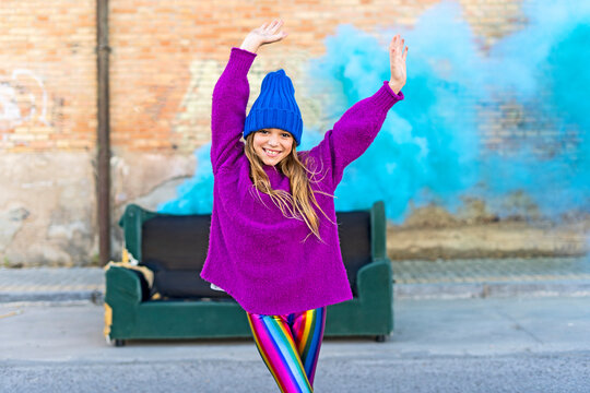 Young girl with sofa and turquoise color powder in the background