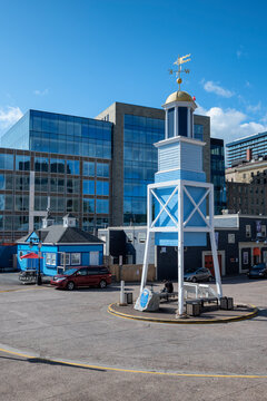 Canada, Nova Scotia, Halifax, Dockyard Clock standing against modern building
