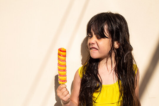 Portrait of little girl with popsicle