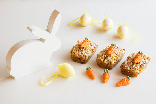 Three mini carrot cakes with marzipan carrots and Easter decoration