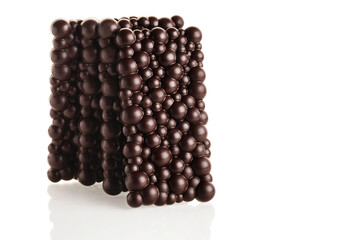 Black raw chocolate stack of bars on a white background. Isolate.