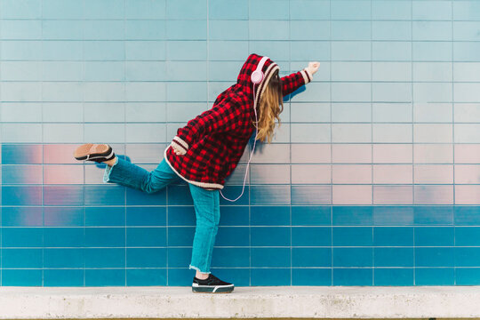 Teenage girl with headphones having fun outdoors