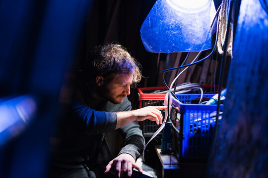 Man Sitting Backstage At Theatre Looking At Script